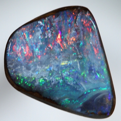 SOLID BOULDER OPAL Bright red sparkles over blue